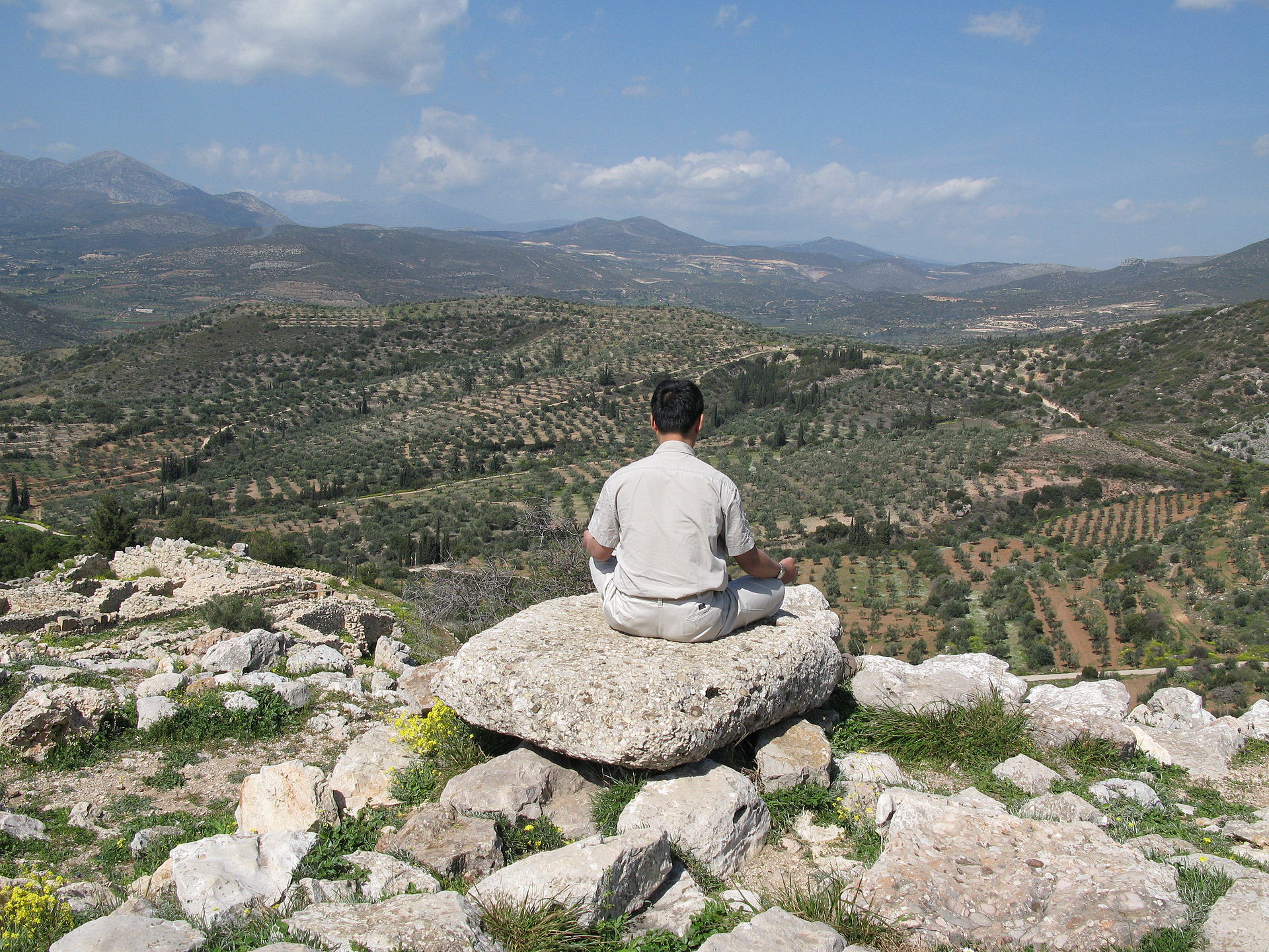 Man meditating on a mountain - handing stress is an important topic we discuss at our father son christian retreat in colorado