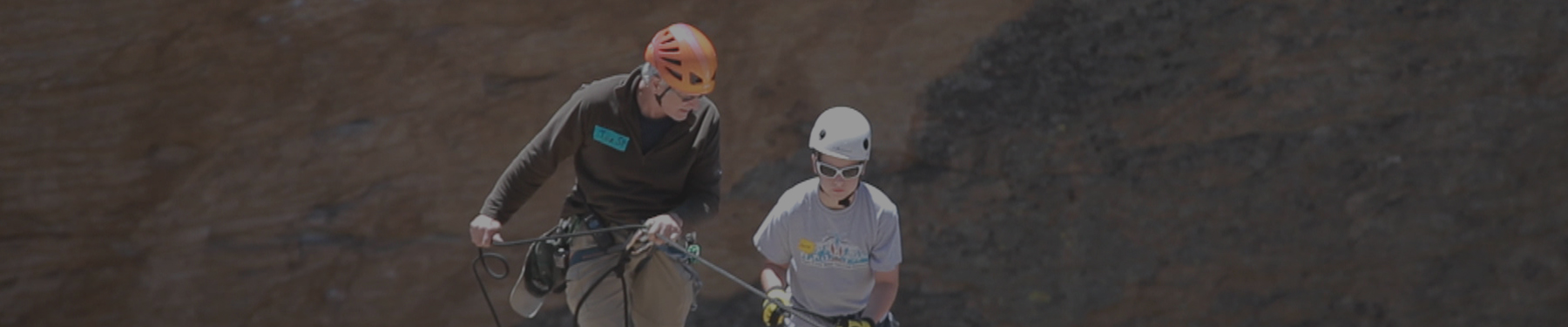 Father and son riding bike at a christian men's retreat that also includes sons